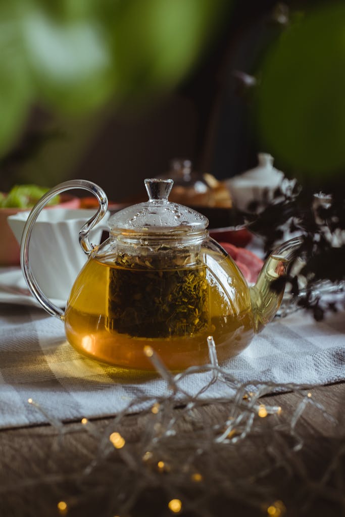 Close-up of a glass teapot with green tea on a table setting, Baku, Azerbaijan.